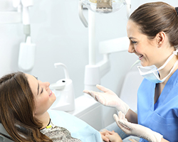 A dentist answering questions about a root canal in Rolling Meadows