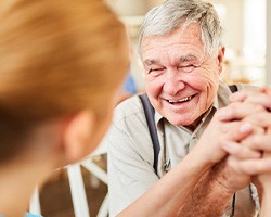 Woman in Rolling Meadows smiling freely after receiving dentures 