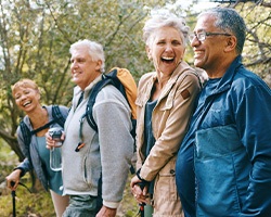 Patient talking with friends after getting dentures