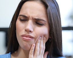 Woman holding jaw