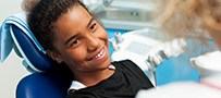 Smiling teen girl in dental chair