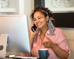 person speaking on the phone and smiling