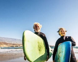 surfers who are both smiling