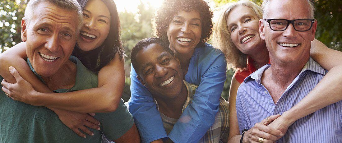 Three couples smiling outdoors