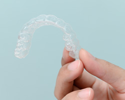 Patient holding clear aligner