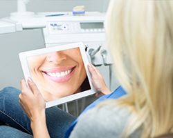 Woman looking at digital images on tablet