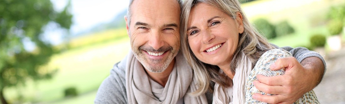 Mature couple smiling outside