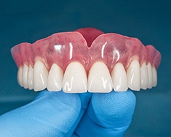 Closeup of dentist holding full denture