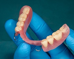 Closeup of dentist holding partial denture