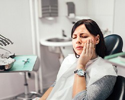 Woman with toothache at dentist's office 