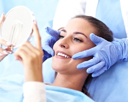 dentist showing patient their improved smile