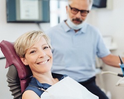 Woman smiling while visiting implant dentist in Rolling Meadows