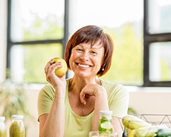 woman holding a yellow apple