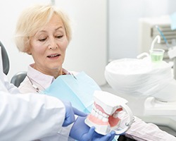elderly woman at a dental implant consultation 