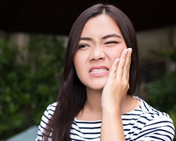 Woman holding jaw in pain