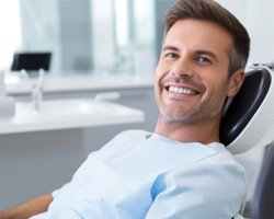 Happy, smiling patient in dental treatment chair