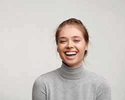 woman in gray sweater laughing