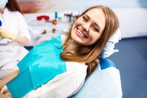 woman smiling in dentist chair after root canal
