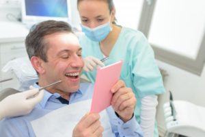 patient looking closer at the black line around dental crown