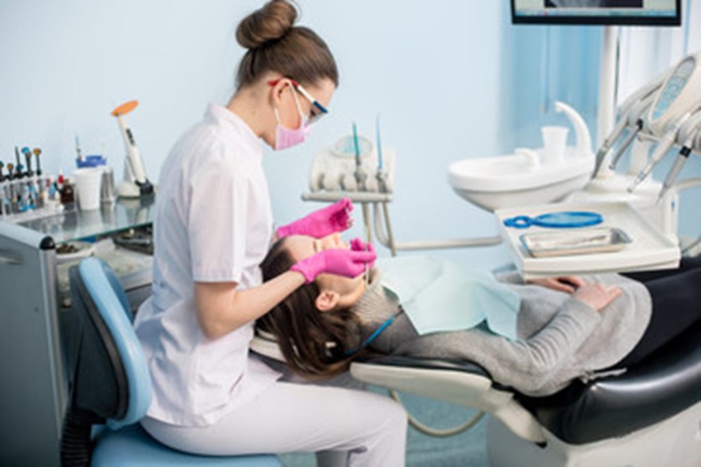 patient getting dental checkup and cleaning