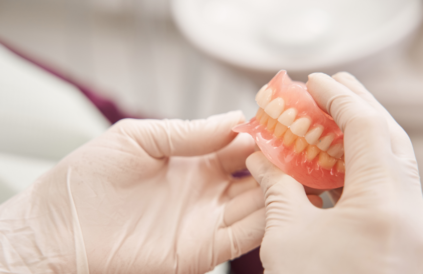 Dentist holding dentures